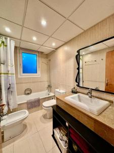 a bathroom with a sink and a toilet and a tub at Villa Martina in Cambrils +30 photos