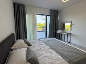 a bedroom with a large bed and a window at Villa Violeta & Katharina in Rovinjsko Selo +30 photos