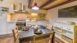 a kitchen with a table with chairs and a chalkboard at Casa Il Maestro by Rentbeat in Civitavecchia