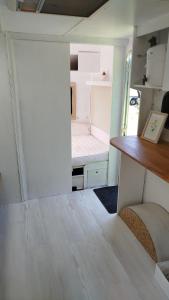 a small room with a bed in a tiny house at Heller Wohnwagen auf Tierschutz Landhof inmitten der Natur in Selmsdorf +18 photos