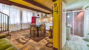 a kitchen and dining room with a table and chairs at Casa Il Maestro by Rentbeat in Civitavecchia +46 photos