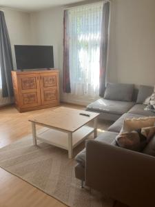 a living room with a couch and a coffee table at Harderblick in Interlaken