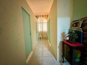 an empty hallway with a plant on a table in a room at Backpacker's Bed - No Parking in Abu Dhabi