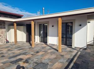 a building with wooden columns on a patio at Casa neve e natura in Castel di Sangro