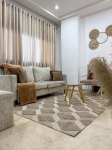 een woonkamer met een bank en een tafel bij Jotis home in Abidjan