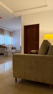 een woonkamer met een bank en een houten deur bij Jotis home in Abidjan