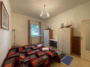 a bedroom with a bed and a desk in it at Villetta delle Acacie in Pisa