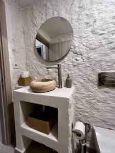 a bathroom with a sink and a mirror on the wall at Aporte Hotel Cesme in Çeşme