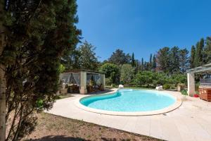 a swimming pool in a backyard with a gazebo at Casina San Martino in Uggiano Montefusco