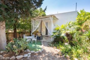 a patio with a table and chairs in a garden at Casina San Martino in Uggiano Montefusco