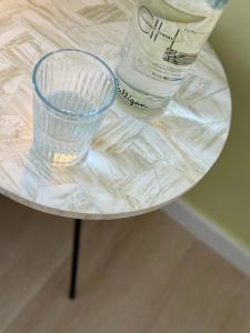 a glass cup and a water bottle on a table at Canaryislandshost l Sol in Tías