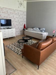 a living room with a couch and a tv at Harmonia2 in Keminmaa
