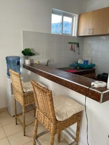 a kitchen with two chairs and a counter top at Joy BNB in Mombasa
