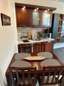 eine Küche mit einem Holztisch und Stühlen in der Unterkunft Daniel's Suite - 4 Season apartment in Bansko