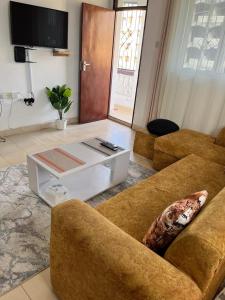a living room with two couches and a coffee table at Joy BNB in Mombasa +5 photos