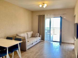 a living room with a couch and a table at Apartments Amilija in Radovici
