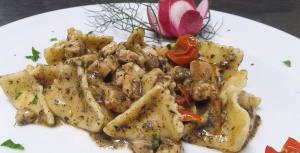 a white plate of food with chicken and potatoes at Hotel Ristorante Borgo La Tana in Maratea