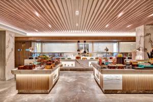 a large kitchen with a lot of food on the counters at Hilton Garden Inn Jabalpur in Jabalpur