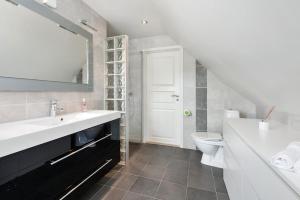 a bathroom with a sink and a toilet at Large apartment with 5 bedrooms, 2 bathrooms and roof terrace in Ålesund +11 photos