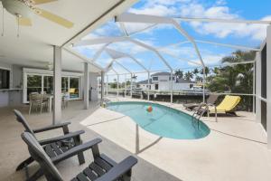 a house with a swimming pool on a patio at Boater’s paradise with unmatched water views in Marco Island