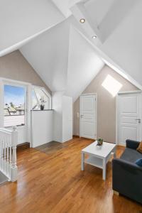 a living room with a couch and a table at Large apartment with 5 bedrooms, 2 bathrooms and roof terrace in Ålesund