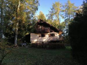 a cabin in the middle of a field with trees at Na samotě u lesa in Libňatov