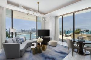 a living room with a couch and a tv at Atlantis The Royal in Dubai