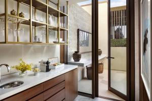 a kitchen with a sink and a glass door at Atlantis The Royal in Dubai