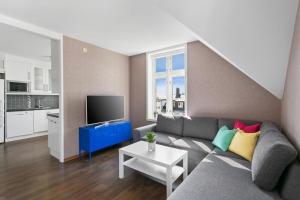a living room with a couch and a tv at Large apartment with 5 bedrooms, 2 bathrooms and roof terrace in Ålesund