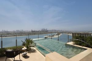a swimming pool on the roof of a building overlooking the water at Atlantis The Royal in Dubai