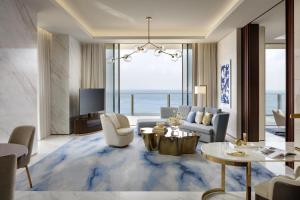 a living room with a couch and a table at Atlantis The Royal in Dubai