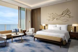 a hotel room with a bed and a couch at Atlantis The Royal in Dubai