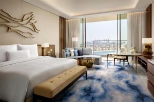 a bedroom with a large bed and a living room at Atlantis The Royal in Dubai