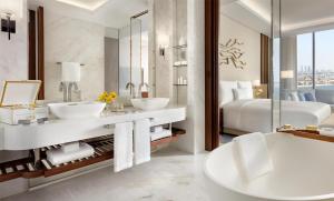 a bathroom with two sinks and a bed at Atlantis The Royal in Dubai