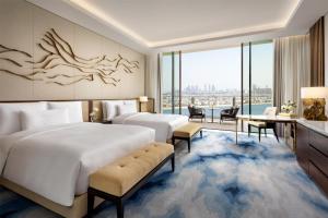 two beds in a hotel room with a view at Atlantis The Royal in Dubai