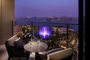 a room with a view of a fountain on a balcony at Atlantis The Royal in Dubai