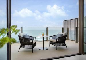 two chairs and a table on a balcony with the ocean at Atlantis The Royal in Dubai