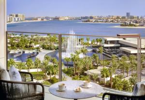 a view of the water from a hotel balcony with a table and chairs at Atlantis The Royal in Dubai