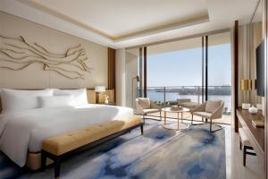 a bedroom with a large bed and a large window at Atlantis The Royal in Dubai