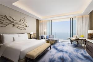 a bedroom with a large bed and a living room at Atlantis The Royal in Dubai