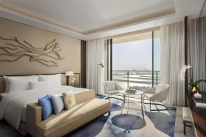 a hotel room with a bed and a balcony at Atlantis The Royal in Dubai