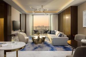 a living room with a couch and a table at Atlantis The Royal in Dubai