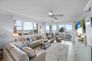 a living room with a couch and a table at Somerset three-bedroom end unit beachfront condo in Marco Island