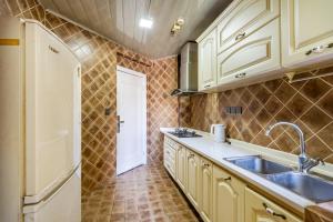 a kitchen with white cabinets and a sink at Aixin Mountain City Zhijiang Homestay in Chongqing +195 photos