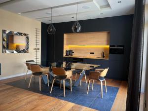 a dining room with black walls and a table and chairs at Basilica Panorama Luxury in Budapest