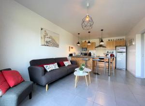 a living room with a couch and a kitchen at Haritza in Ahetze