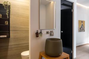a bathroom with a sink and a toilet at Garment District Suites in Athens +85 photos