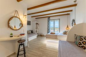 a bedroom with a king sized bed and a mirror at Marine Dream in Plaka