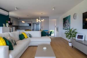 a living room with a white couch and a table at Casagrande in Krk