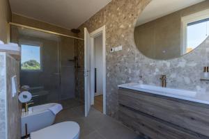 a bathroom with a tub and a sink and a mirror at Casagrande in Krk +40 photos